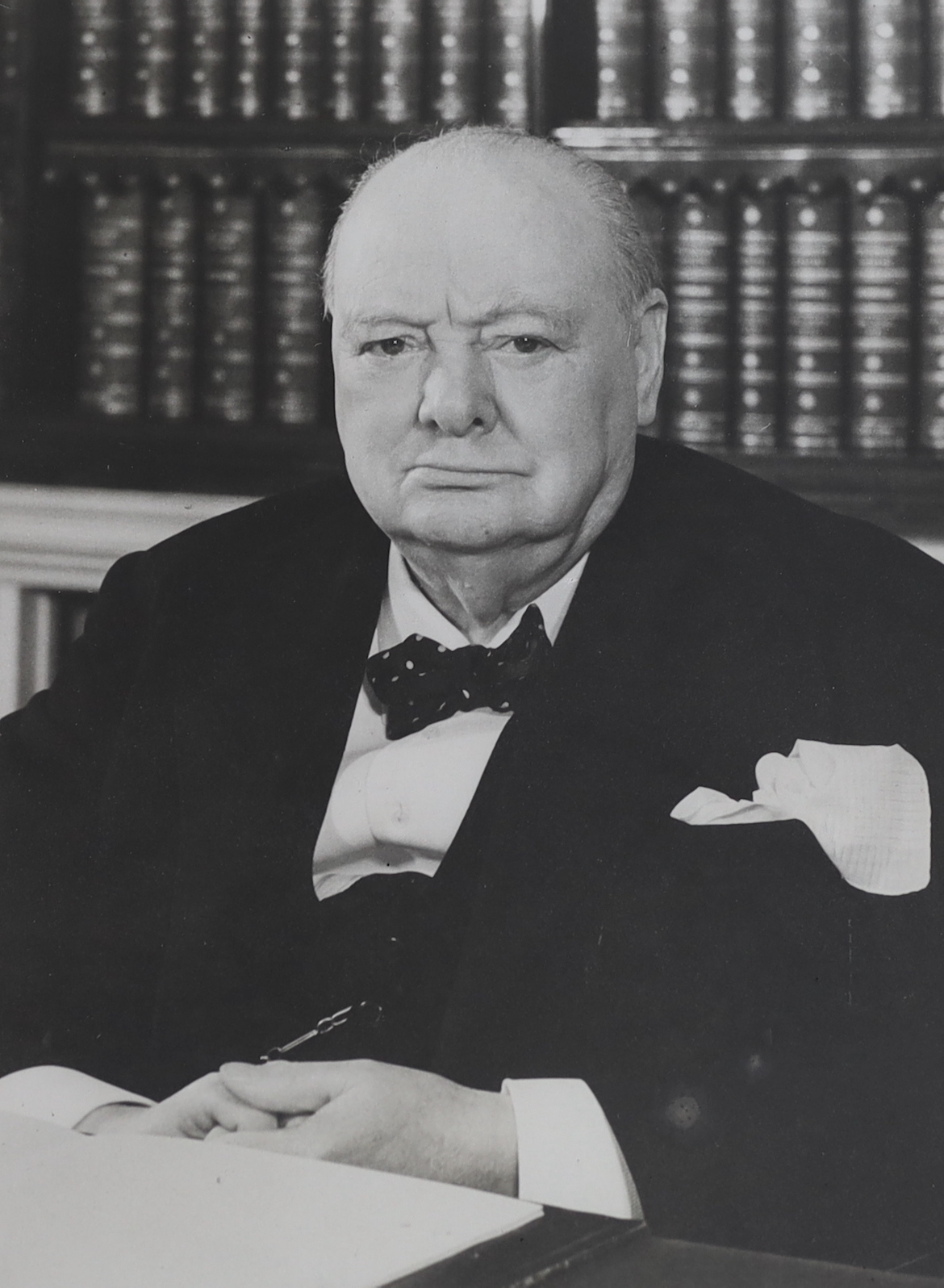 A large black and white photograph of Sir Winston Churchill seated at his desk, visible sheet 58 x 42.5cm